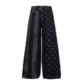 Wide-leg black distressed denim jeans with star print and vertical stripe panels, front and back view