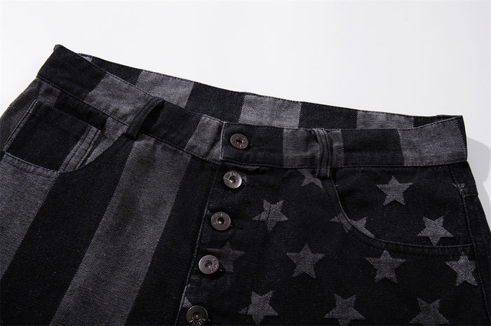 Close-up of black denim waistband and button fly with stars and stripes print