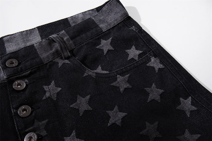 Close-up of front pocket and waist on black denim jeans with star print