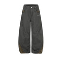 Front view of charcoal wide-leg pants with leopard-print pocket accents and curved lower-leg panels