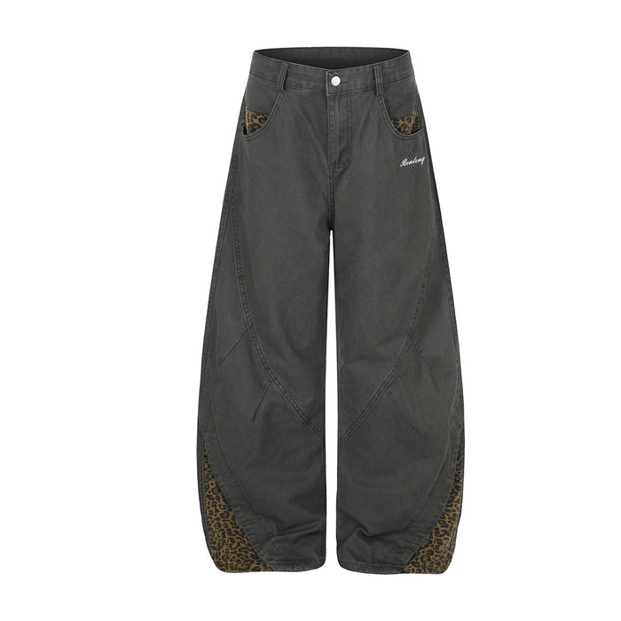 Front view of charcoal wide-leg pants with leopard-print pocket accents and curved lower-leg panels