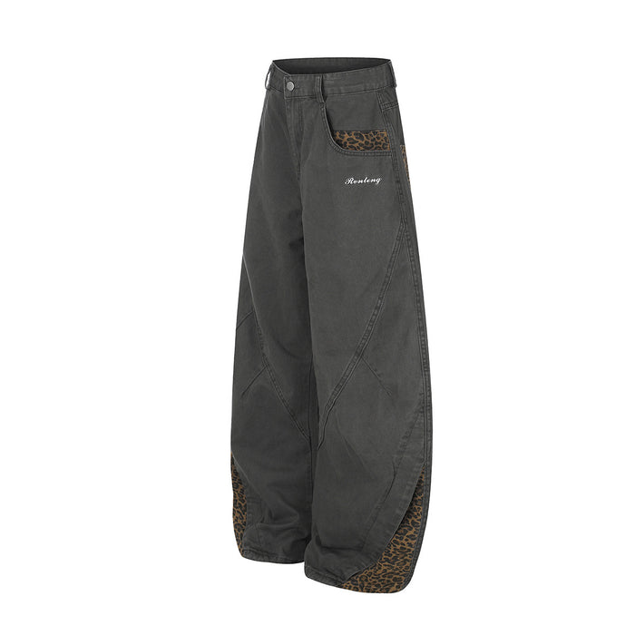 Three-quarter front view of charcoal wide-leg pants with leopard-print pockets and lower-leg inserts