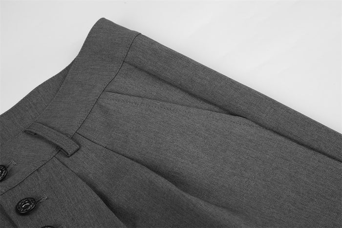 Close-up of gray waistband and front pleat detail on dress pants