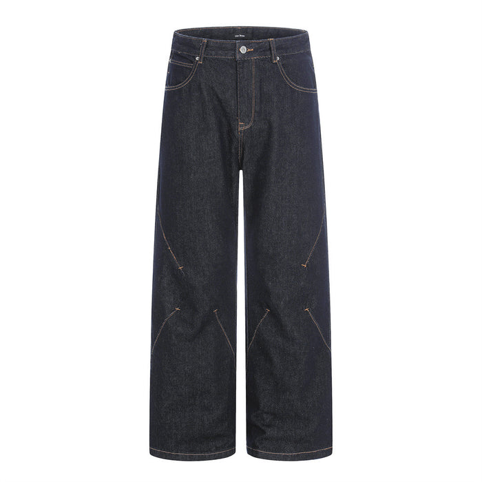 Men's wide-leg raw indigo denim jeans with diagonal orange contrast seam detailing, front and back view