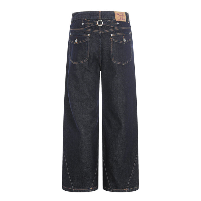 Back view of dark wide-leg raw denim jeans with patch pockets and diagonal stitching