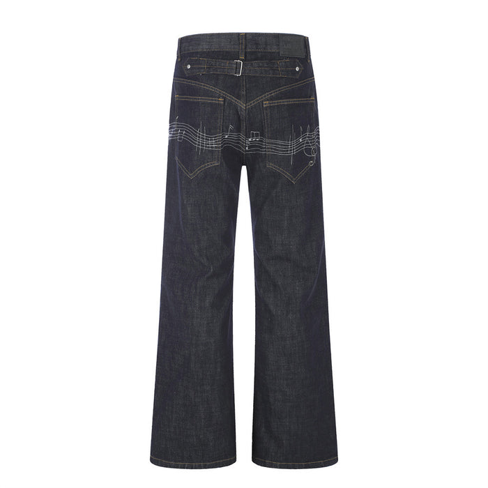 Back view of dark wide-leg raw denim jeans with music note embroidery across the seat