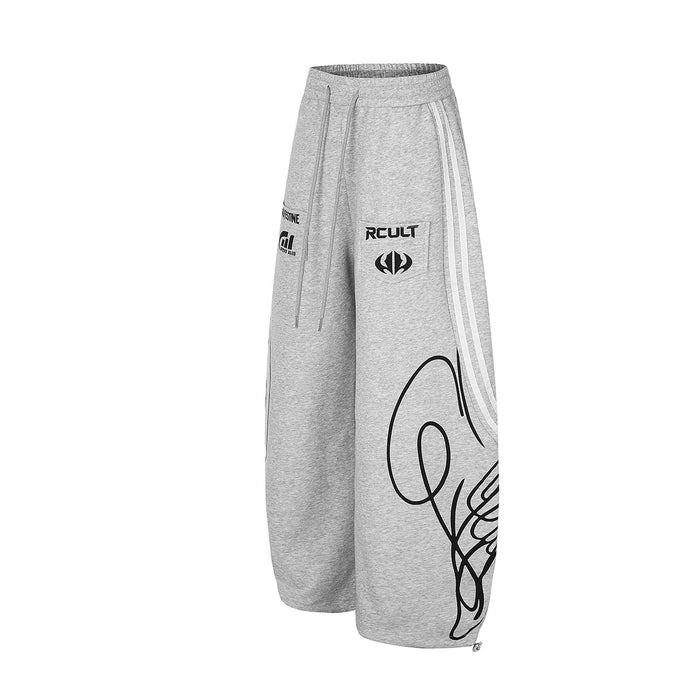 Angled front view of heather gray wide-leg sweatpants with white stripes and a bold black lower-leg graphic