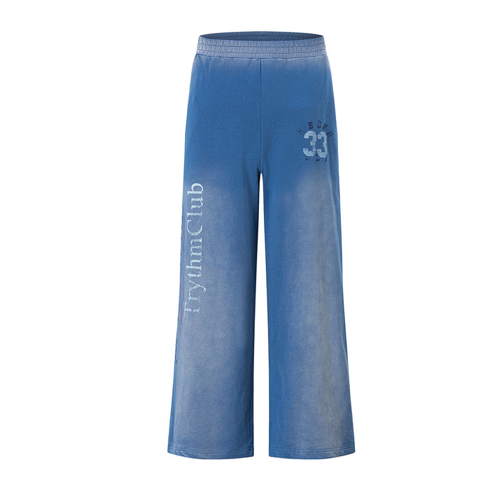 Wide-leg acid-wash sweatpants with distressed collegiate 33 graphic and TrythmClub script, shown in washed blue and washed re