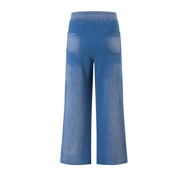 Blue wide-leg sweatpants back view with two rounded patch pockets and faded acid-wash texture