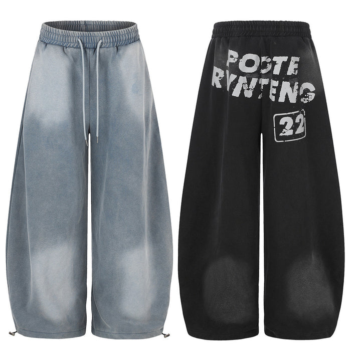 Wide-leg acid wash sweatpants shown front and back in gray and black with white letter print