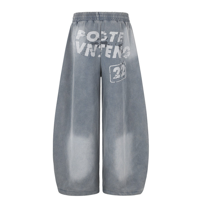 Gray acid wash wide-leg sweatpants back view with white distressed letter print