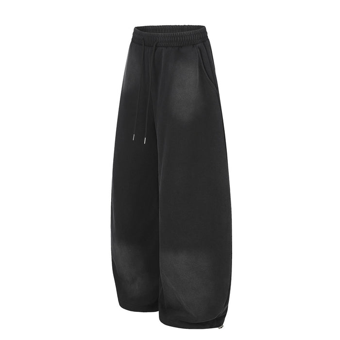 Black wide-leg sweatpants angled side view with elastic waist and drawstring
