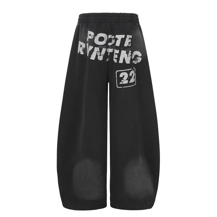 Black wide-leg sweatpants back view with white distressed letter print on the seat