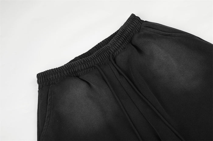 Black sweatpants close-up of elastic waistband and gathered waist detail
