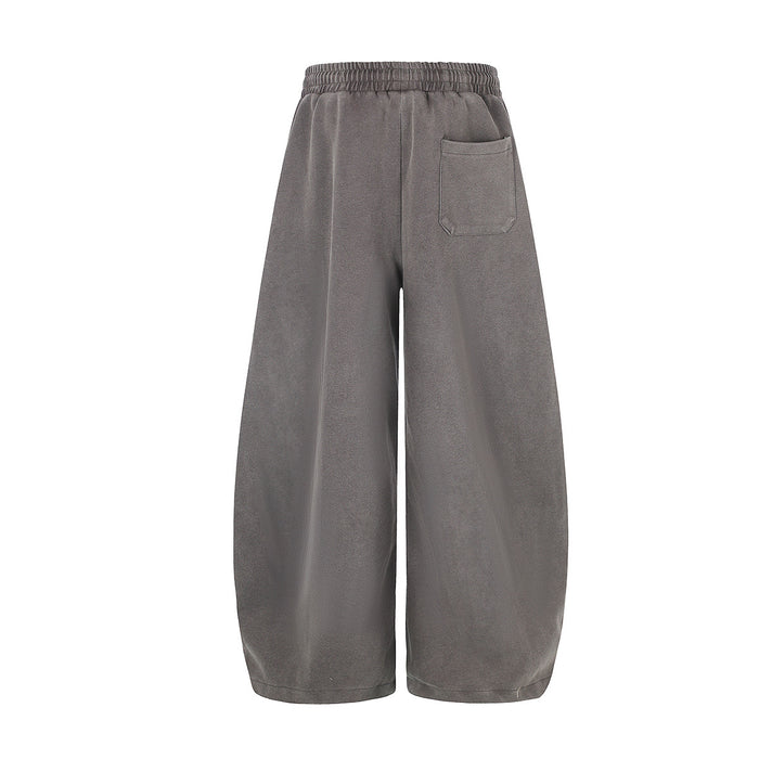 Back view of gray wide-leg sweatpants with an elastic waistband and single rear patch pocket