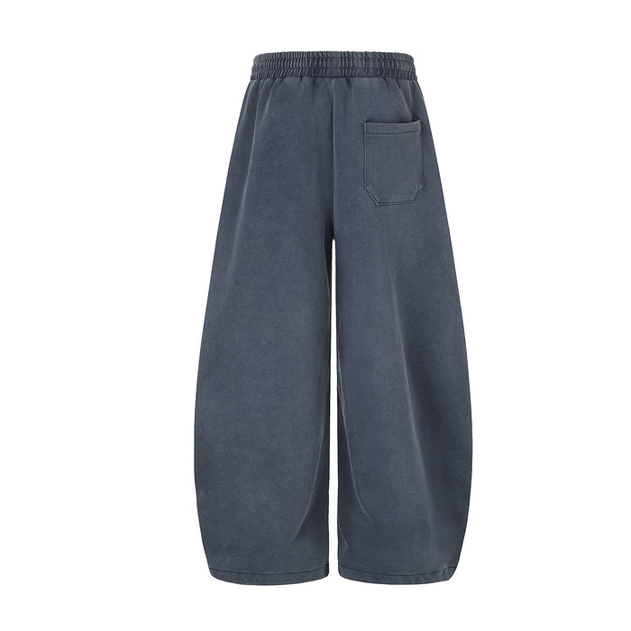 Back view of blue wide-leg sweatpants with an elastic waistband and single rear patch pocket