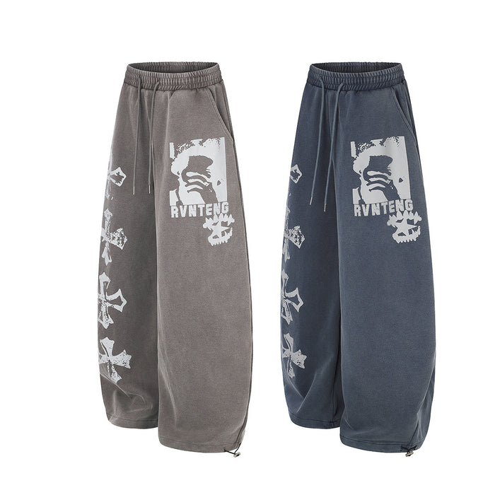 Angled comparison of gray and blue wide-leg sweatpants with matching white graphic prints and cross motifs