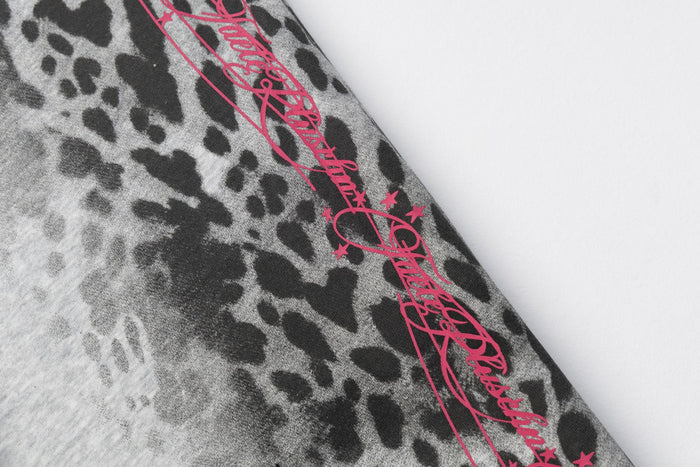 Black leopard-print sweatpants panel featuring a bright pink script and star graphic along the side