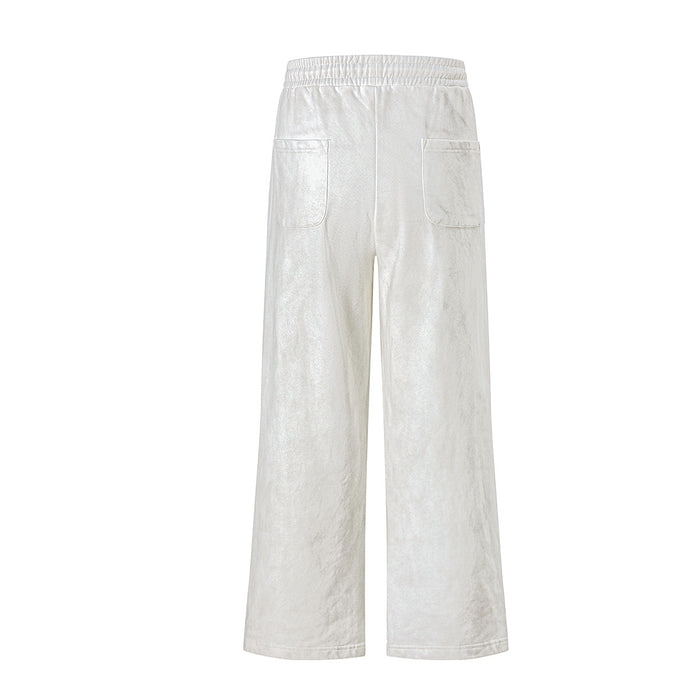 Back view of cream wide-leg sweatpants with an elastic waistband and two rear patch pockets