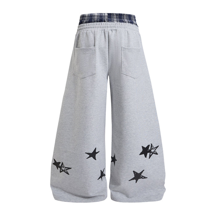 Gray wide-leg sweatpants shown from the back with plaid waistband, two rear pockets, and black star graphics