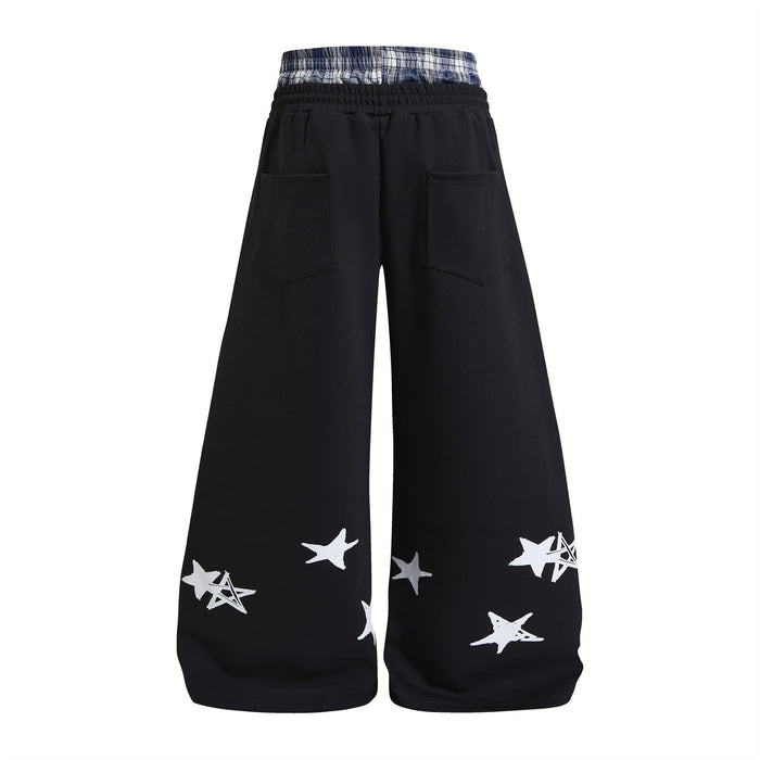 Black wide-leg sweatpants back view with plaid waistband, two rear pockets, and white and black star graphics