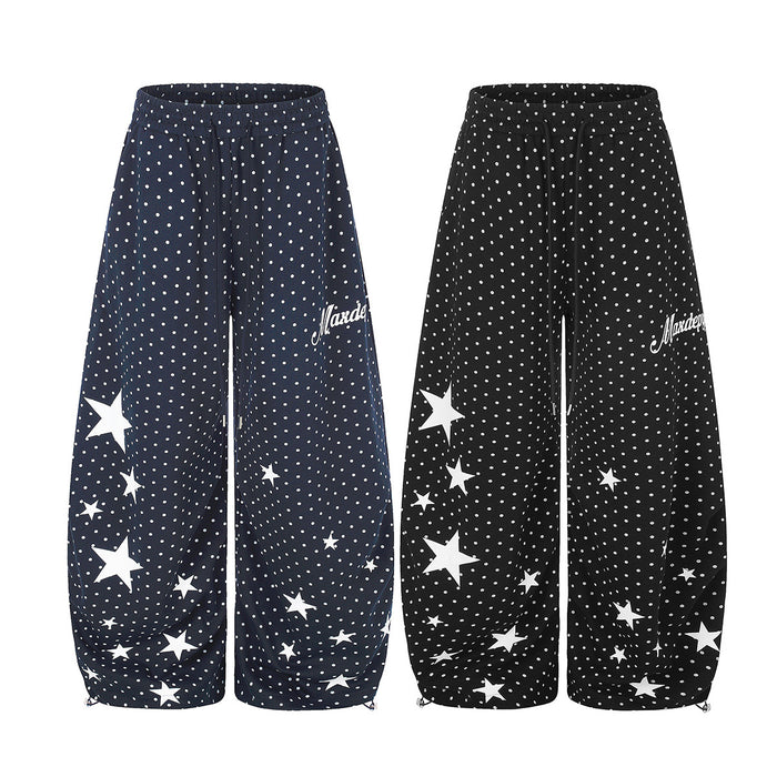 Wide-leg sweatpants in navy and black with white polka dots, scattered star prints, and elastic drawstring waists