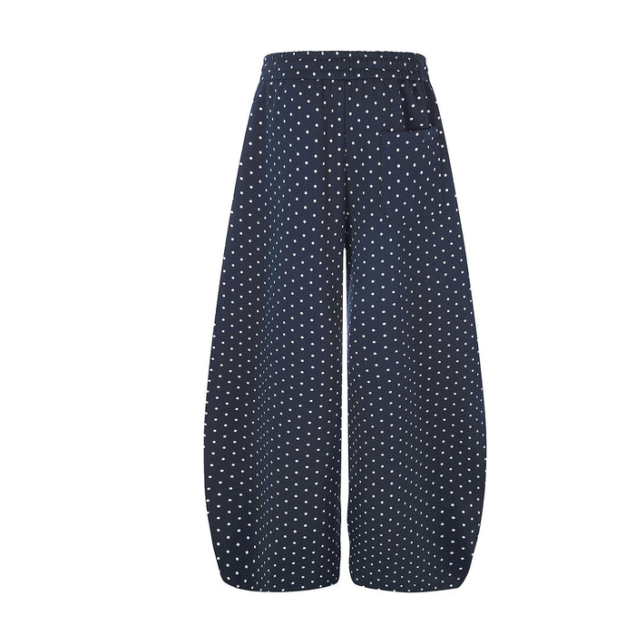 Back view of navy wide-leg sweatpants covered in small white polka dots