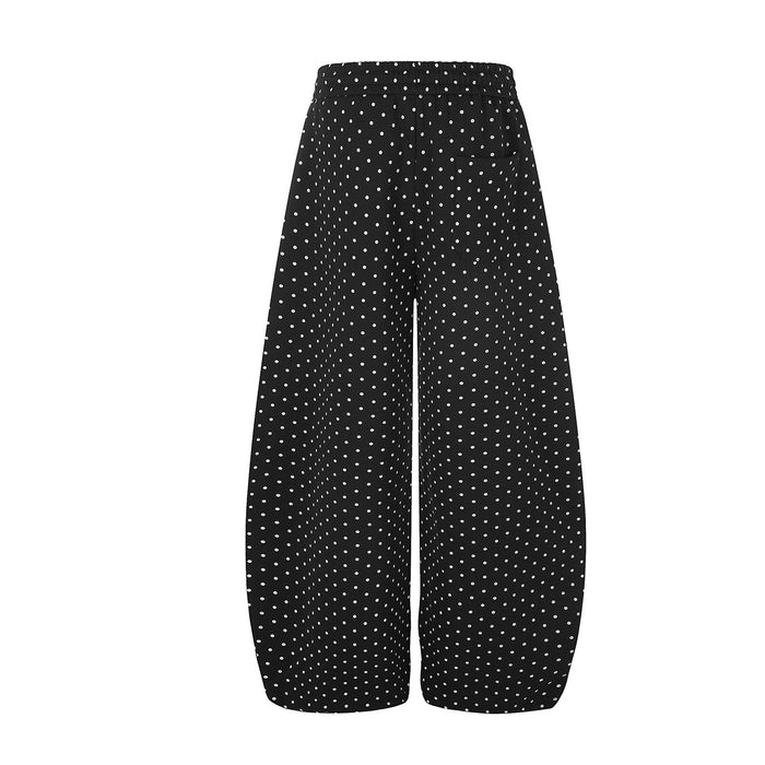 Back view of black wide-leg sweatpants featuring an all-over small white polka dot pattern