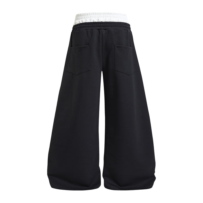 Black wide-leg sweatpants shown from the back with two patch pockets and a white layered waistband