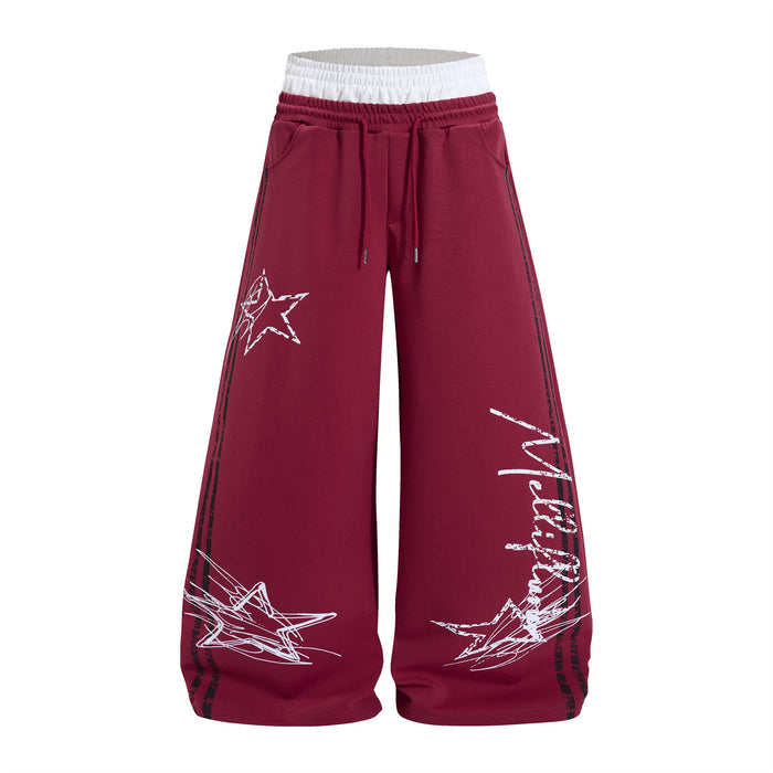 Burgundy wide-leg sweatpants front with white star graffiti graphics, side stripes and drawstring waist