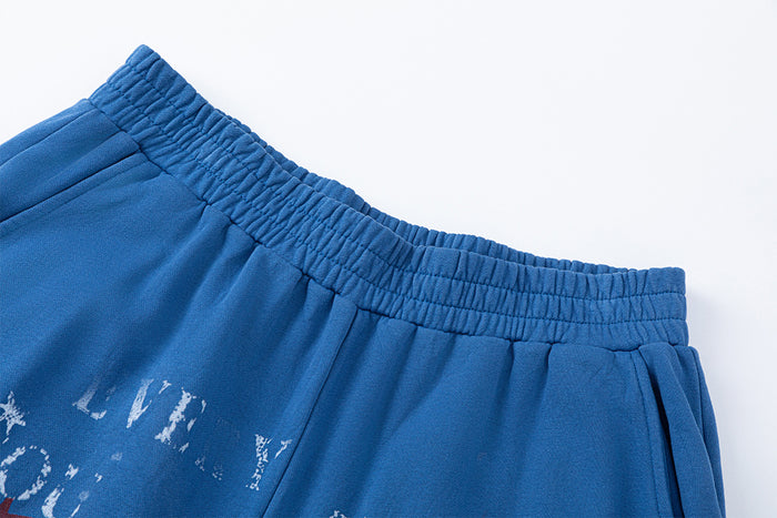 Close-up of the gathered elastic waistband and side pocket on blue wide-leg pants