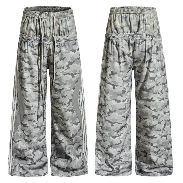 Front and back view of grey camouflage wide-leg mesh track pants with side stripe panels and elastic drawstring waistband