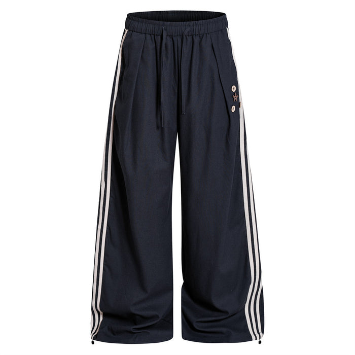 Navy wide-leg track pants front view with cream triple side stripes, drawstring waist and decorative accents