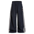 Navy wide-leg track pants front view with cream triple side stripes, drawstring waist and decorative accents