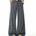 Cement grey wide-leg washed denim jeans with pleated waistband and metal button hem detail, front and back view