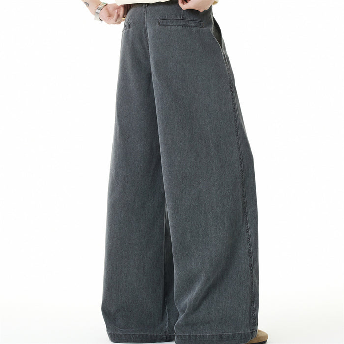 Side view of wide-leg gray denim jeans on model, showing loose drape and straight hem