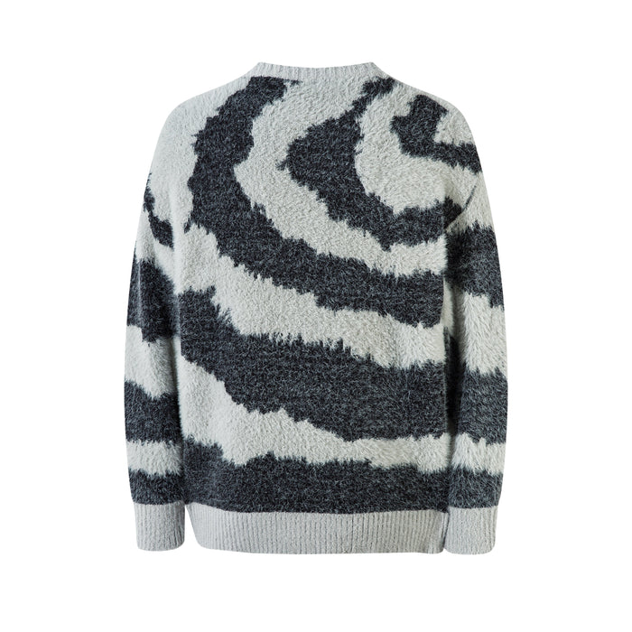 Back view of oversized crew neck sweater with black and white zebra print and fluffy knit texture