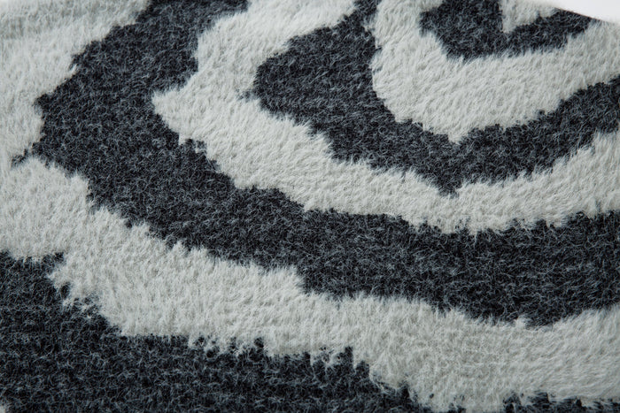 Close-up of black and white zebra stripe pattern on the fluffy knit sweater