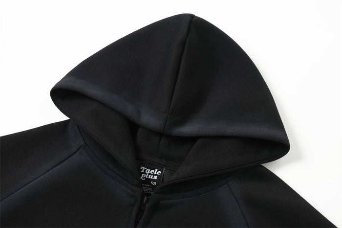 Black hoodie hood and upper chest close-up with front zipper and label visible