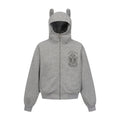 Gray zip-up hoodie with ear-tipped hood, front pockets, and small dark cross graphic on the chest