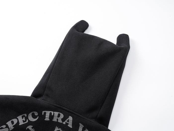 Back close-up of black ear-tipped hood with visible seams and partial printed graphic below